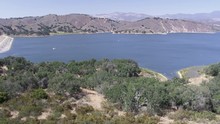 Aerial Drone Shot Of A Trails Leading To A Lake And Dam (Cachuma Lake, California)
