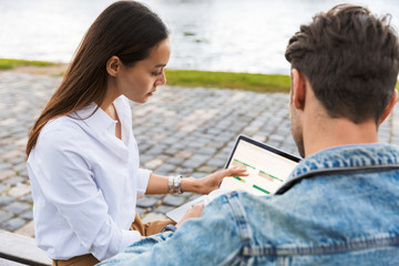 Wall Mural - Attrative young couple using laptop computer