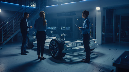 Poster - Team of Automobile Design Engineers in Automotive Innovation Facility Working on Electric Car Platform Chassis Prototype that Includes Tires, Suspension, Engine and Battery.