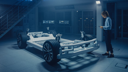 Poster - Automobile Engineer Working on Electric Car Chassis Platform, Using Tablet Computer Augmented Reality with 3D CAD Software Modelling. Innovative Facility: Vehicle Frame with Wheels, Engine, Battery
