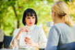© be free - Discussing rumors. Trustful communication. Friendship sisters. Friendship meeting. Closest people. Girls friends drink coffee talk. Conversation women cafe terrace. Friendship friendly relations