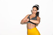 © Drobot Dean - Smiling pleased beautiful young sports fitness woman isolated over white wall background using watch clock listening music with headphones.