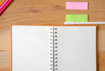 Notebook and white pen on woodworking,Top view with copy space.