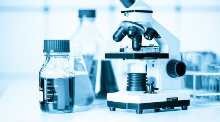 Canvas Print - Test tubes and flasks and microscope in a chemical laboratory