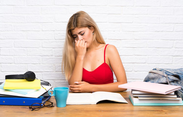 Teenager student girl at indoors having doubts