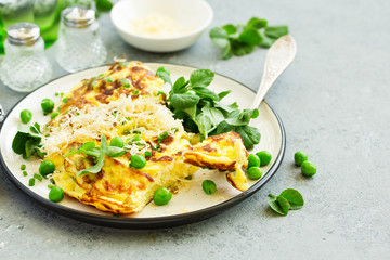 Wall Mural - Breakfast. Frittata Italian omelet with green peas and salad.