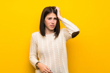 Wall Mural - Young woman over isolated yellow wall with an expression of frustration and not understanding