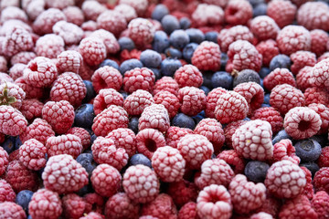 Poster - Background of frozen berries. Top view of raspberries and blueberries.