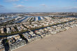 Afternoon aerial view of homes, streets, marina, waterways and Venice Beach in Los Angeles California.
