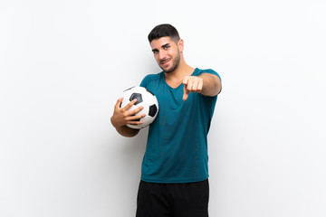 Handsome young football player man over isolated white wall