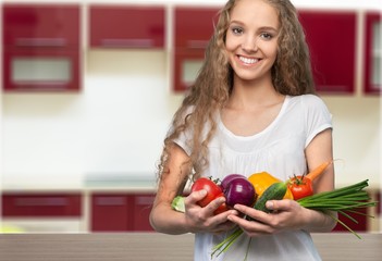 Wall Mural - Young woman in white clothes holding fruits