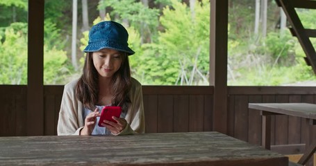 Canvas Print - Woman use of mobile phone in the wooden house