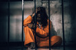 © reewungjunerr - Portrait of women desperate to catch the iron prison,prisoner concept,thailand people,Hope to be free,If the violate the law would be arrested and jailed.