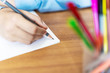 schoolgirl doing homework with pencil on paper, back to school comcept