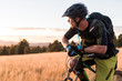 © Cavan Images - Male mountain biker resting along Arizonal Trail at sunset