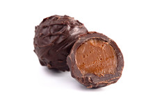 Dark Chocolate Truffles Filled With Caramel On A White Backgroun