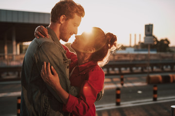 Happy loving couple hugging under beautiful sunlight