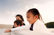 © Cavan for Adobe - Mother and children travelling by boat in river