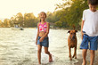 © Cavan for Adobe - Girl (6-7) and boy (8-9) walking with dog along lakeshore