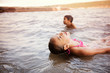 © Cavan for Adobe - Friends (8-9) swimming in river