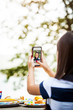 © Cavan for Adobe - Girl taking selfie at table outdoors