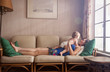 © Cavan for Adobe - Mother with her daughter relaxing on sofa at home