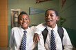 © Cavan for Adobe - Portrait of smiling students standing in school