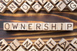 ownership wooden cubes with letters, legal property possession concept, around the cubes random letters, top view on wooden background