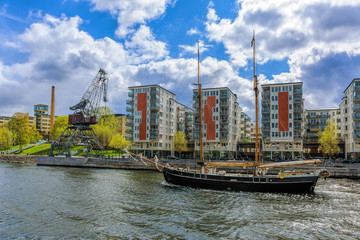 Poster - Twin-masted sailing ship passes underway of the canal Hammarby in Stockholm at sunny spring day.