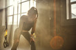 © Friends Stock - Time to rest. Young athletic woman in sportswear looking exhausted while standing in front of windows at gym.