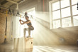 © Friends Stock - Working out. Side view of beautiful athletic woman in sportswear training legs at gym.