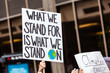 © Valmedia - Environmentalist sign at demonstration. A slogan on an activist's placard reads what we stand for is what we stand on during an environmental protest. Handmade sign by an environment demonstrator.