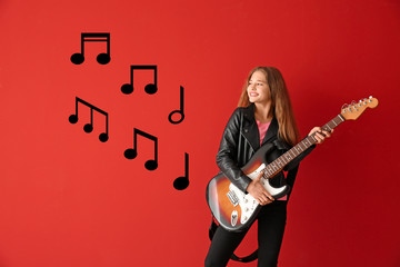 Wall Mural - Teenage girl playing guitar against color background