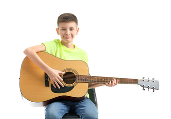 Wall Mural - Teenage boy playing guitar against white background