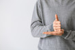 © Pixel-Shot - Young deaf mute man using sign language on light background