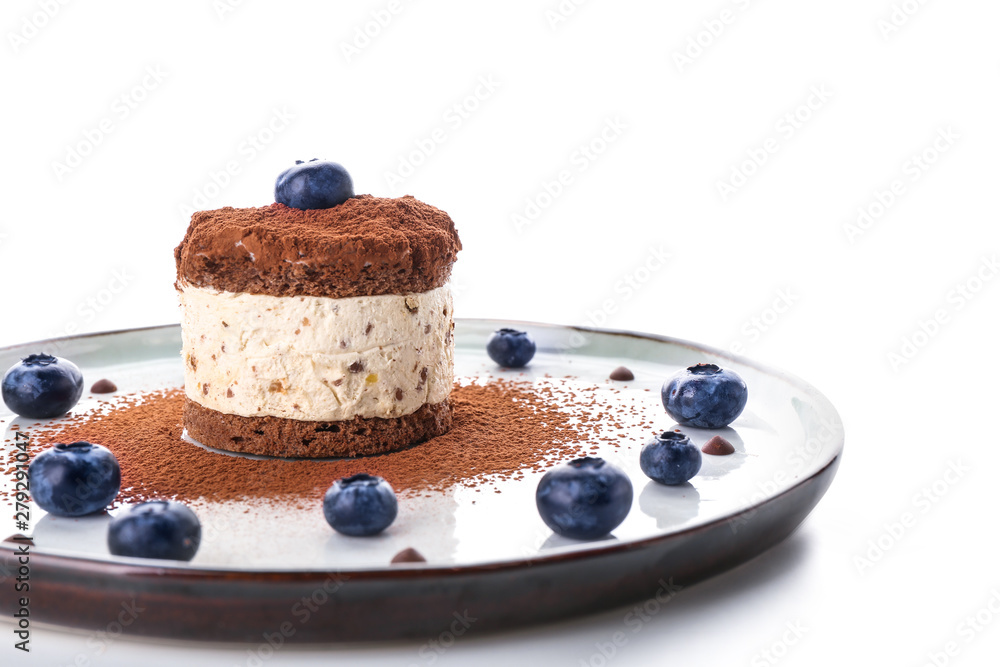 Plate with tasty cake and blueberry on white background