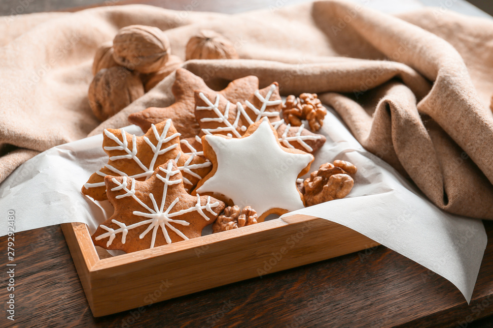 Box with tasty Christmas cookies on table