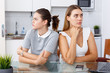 © JackF - Upset young women friends after quarrel sitting at table