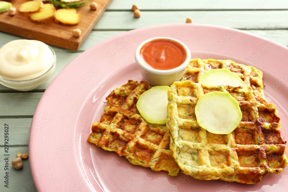 Tasty squash waffles with sauce on plate