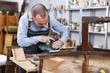 © JackF - Craftsman repairing antique furniture