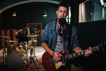 Wall Mural - Music band having rehearsal in a studio