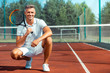 © Viacheslav Yakobchuk - Cheerful athletic man smiling after training on tennis court