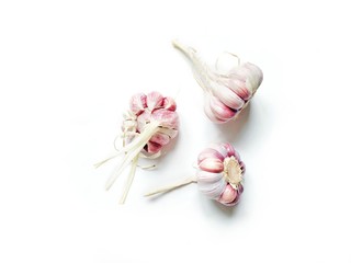 Wall Mural - Three heads of garlic on a white background. Flat lay food photography