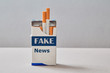 Fake news, disinformation or false information and propaganda concept. A pack of cigarettes with an inscription