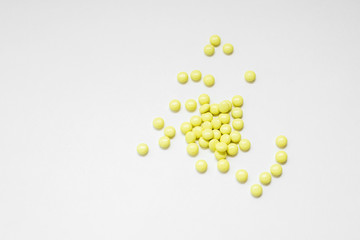 yellow pills on white background