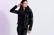 © SHOTPRIME STUDIO - stylish woman in glasses in a leather jacket, black studio