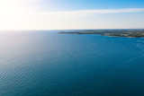 Fototapeta Do akwarium - Aerial view of the ocean with some small islands on a sunny day.