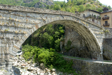 Wall Mural - The arch of the ancient Roman bridge in the town of Pont St Martin in the Aosta Valley - Italy