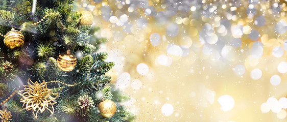 Wall Mural - christmas tree decorated with golden balls toys on a blurred, gold sparkling and fabulous fairy back