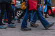 © Valmedia - Environmental activists march in city. Many legs are viewed marching in a town center as environmentalists demonstrate together, bustling street scene during a community protest.